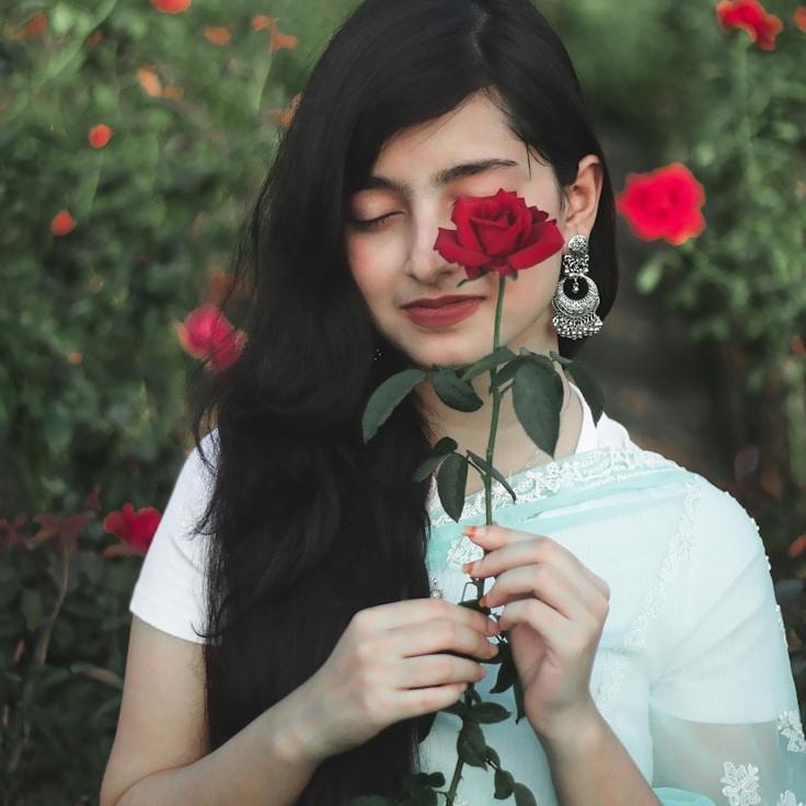 Kaveri Mehta, Lead Design Curator at Chain Spark Dusk, reviewing corporate floral arrangements